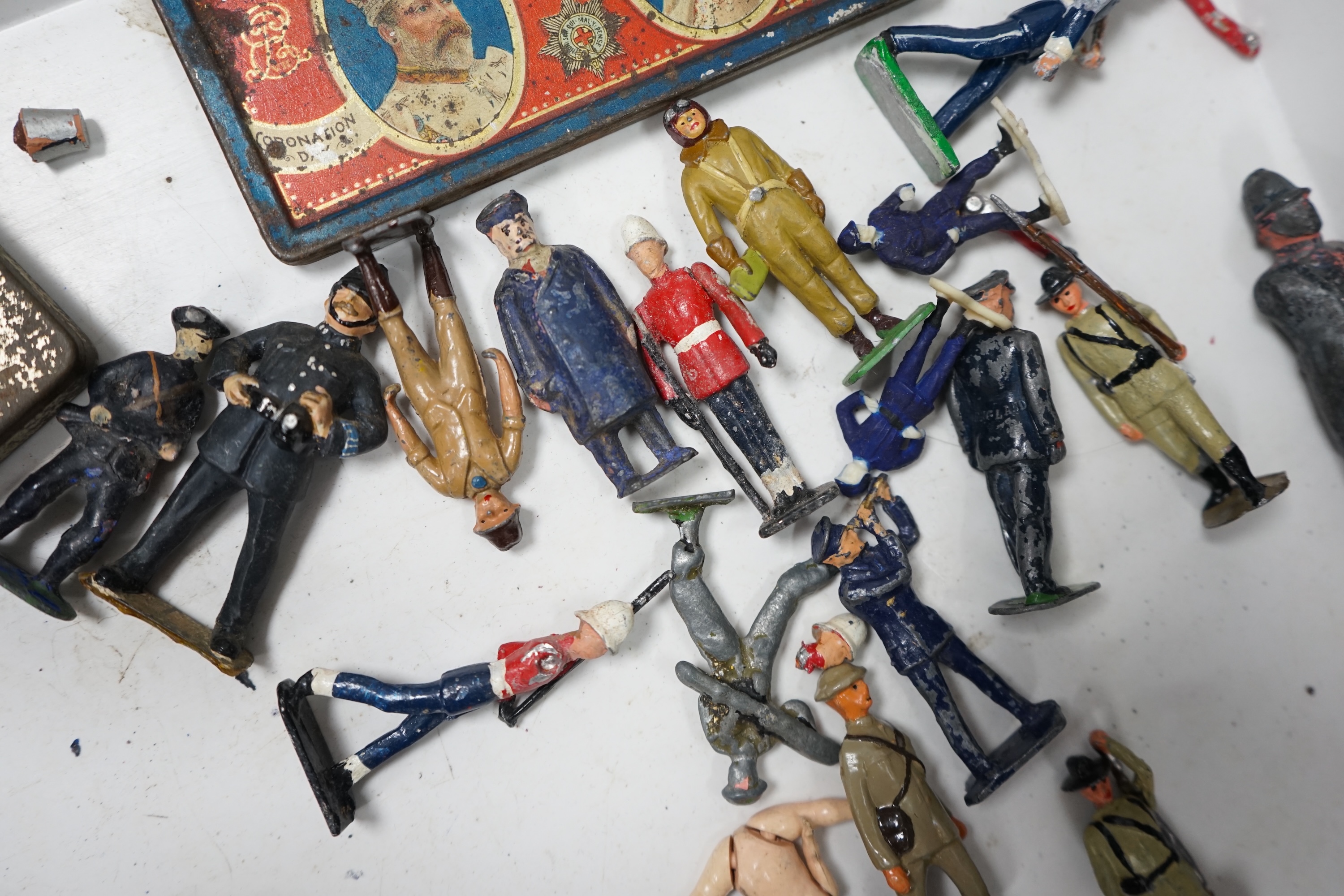 A collection of Britains lead soldiers, mostly British infantry in khaki, including some with gas masks, together with railway station figures by Johillco, etc., plus two Coronation tins, etc. Condition - poor to fair.